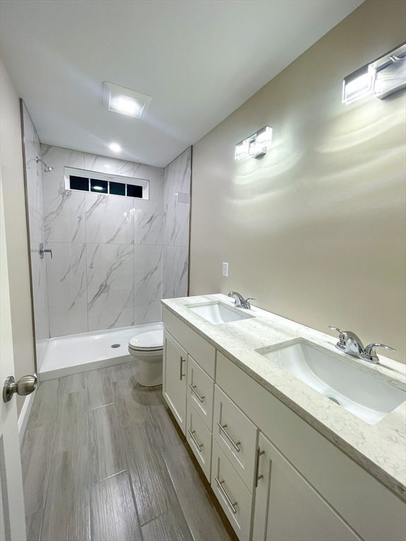 Bathroom, Dual Sink Vanities, Interior, Marble Walls, Recessed Lighting, Wood Texture Flooring