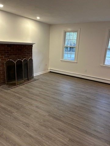 Empty room, Fireplace, Interior, Recessed Lighting, Stone Walls, Wood Texture Flooring