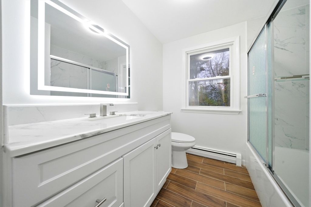 Bathroom, Dual Sink Vanities, Glass Shower, Interior, Marble Walls, Wood Texture Flooring