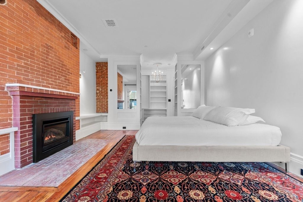 Bedroom, Chandelier, Fireplace, Interior, Recessed Lighting, Stone Walls, Wood Texture Flooring