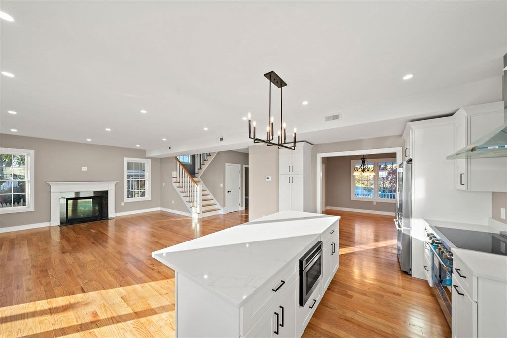 Empty room, Fireplace, Interior, Kitchen, Pendant Lights, Recessed Lighting, Wood Texture Flooring