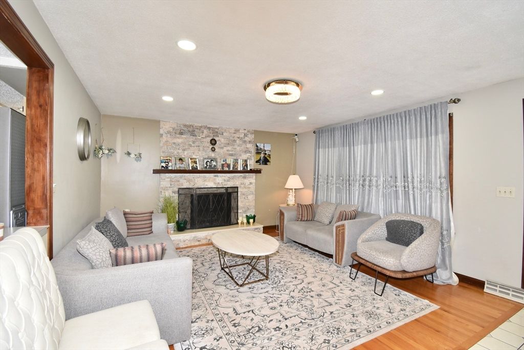 Fireplace, Interior, Living room, Recessed Lighting, Stone Walls, Wood Texture Flooring