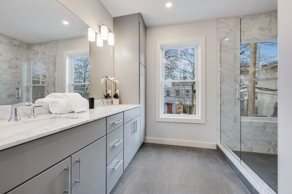 Bathroom, Dual Sink Vanities, Glass Shower, Interior, Marble Walls, Recessed Lighting, Wood Texture Flooring