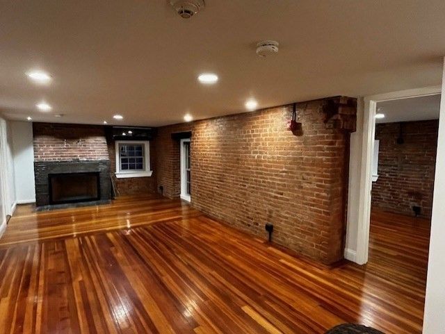Empty room, Fireplace, Interior, Recessed Lighting, Stone Walls, Wood Texture Flooring