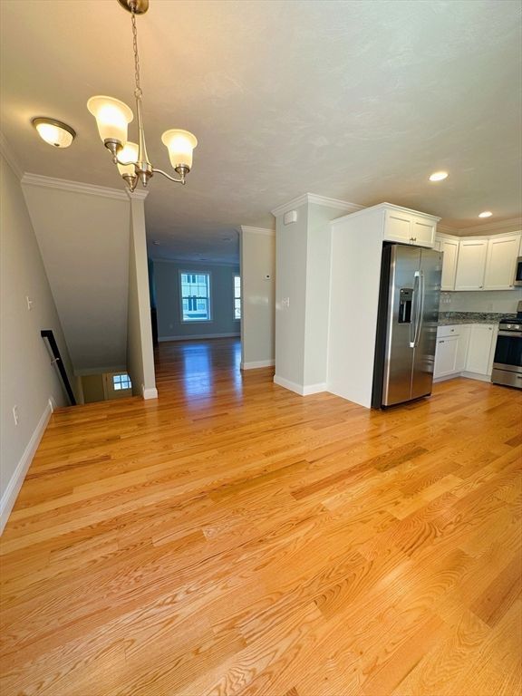 Chandelier, Empty room, Interior, Kitchen, Recessed Lighting, Stainless Steel Appliances, Wood Texture Flooring