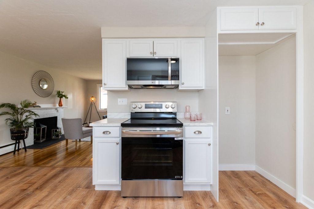 Dining room, Fireplace, Interior, Kitchen, Stainless Steel Appliances, Wood Texture Flooring