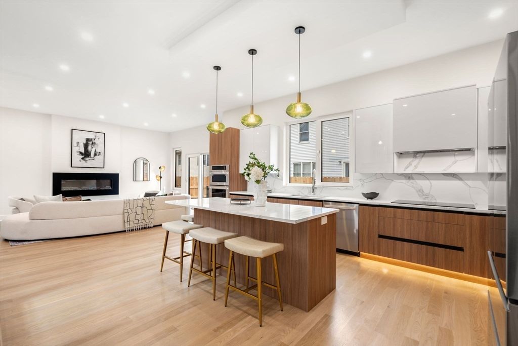 Fireplace, Interior, Kitchen, Living room, Pendant Lights, Recessed Lighting, Stainless Steel Appliances, Wood Texture Flooring