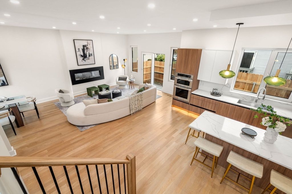 Dining room, Fireplace, Interior, Kitchen, Living room, Pendant Lights, Recessed Lighting, Stainless Steel Appliances, Wood Texture Flooring