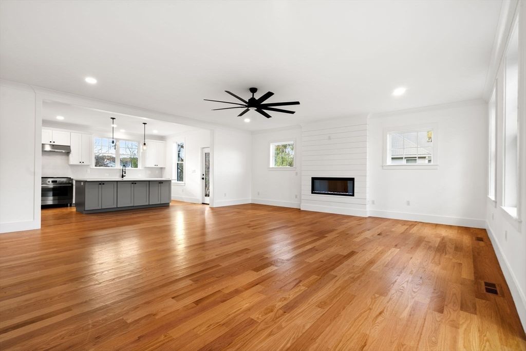 Empty room, Fireplace, Interior, Kitchen, Pendant Lights, Recessed Lighting, Stainless Steel Appliances, Wood Texture Flooring