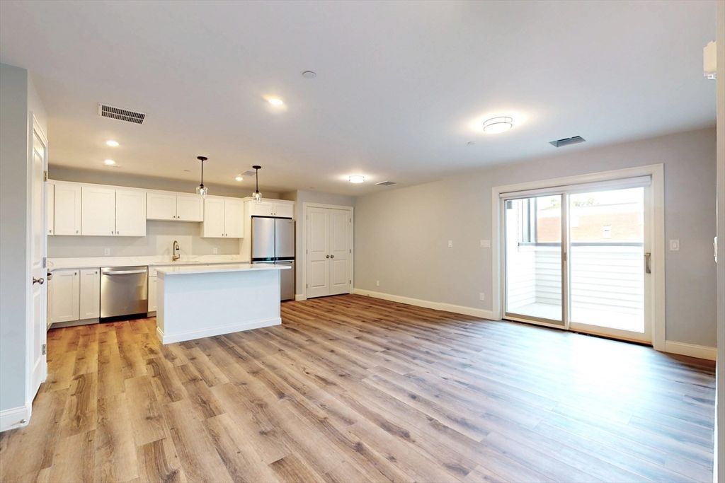 Empty room, Interior, Kitchen, Pendant Lights, Recessed Lighting, Stainless Steel Appliances, Wood Texture Flooring