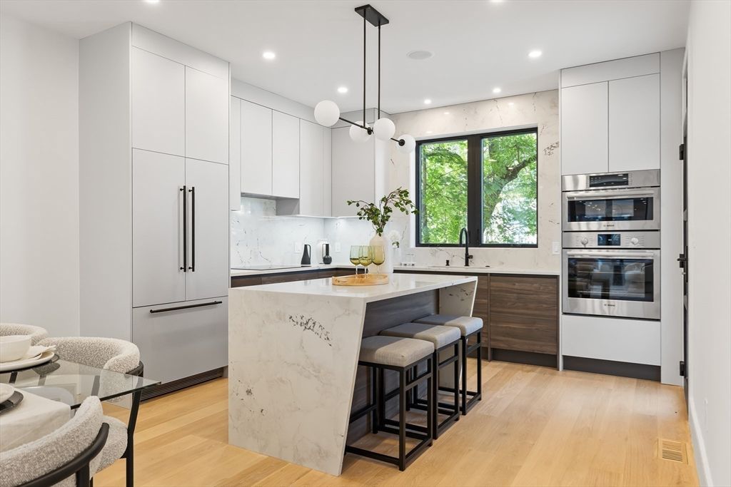 Interior, Kitchen, Marble Walls, Pendant Lights, Recessed Lighting, Stainless Steel Appliances, Wood Texture Flooring