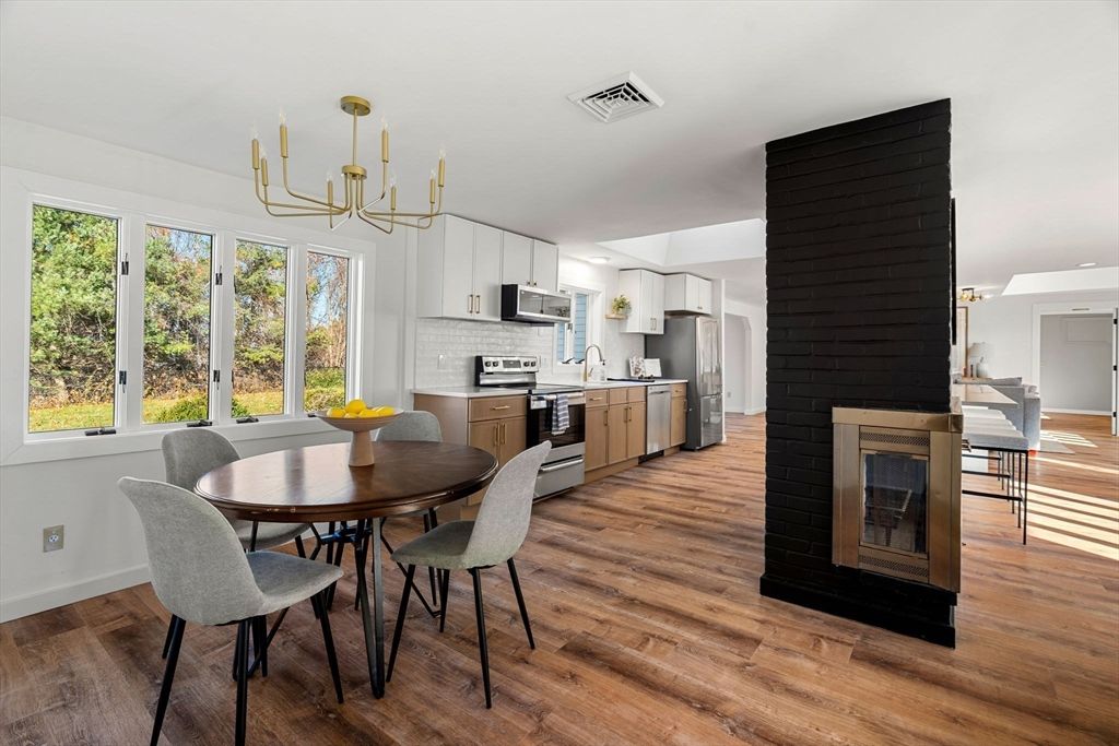 Chandelier, Dining room, Fireplace, Interior, Kitchen, Pendant Lights, Stainless Steel Appliances, Wood Texture Flooring