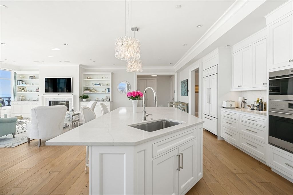 Chandelier, Dining room, Fireplace, Interior, Kitchen, Living room, Pendant Lights, Recessed Lighting, Stainless Steel Appliances, Wood Texture Flooring