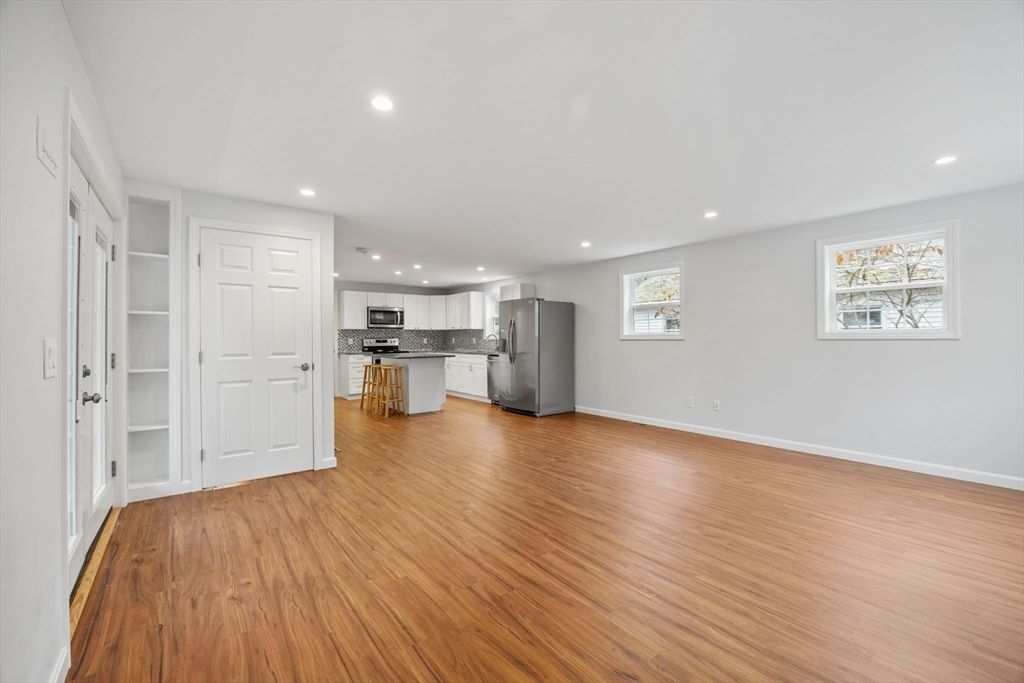 Empty room, Interior, Kitchen, Recessed Lighting, Stainless Steel Appliances, Wood Texture Flooring
