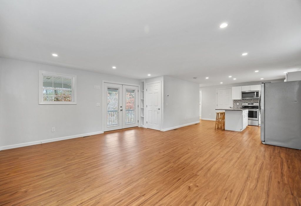 Empty room, Interior, Kitchen, Recessed Lighting, Stainless Steel Appliances, Wood Texture Flooring