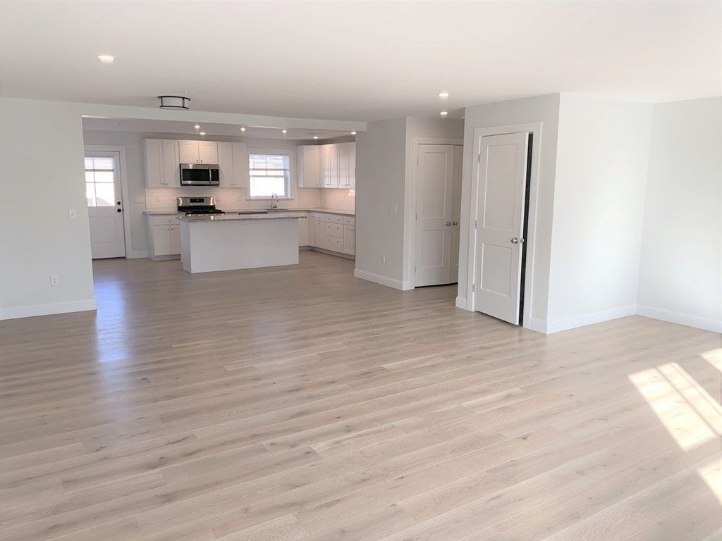 Empty room, Interior, Kitchen, Recessed Lighting, Stainless Steel Appliances, Wood Texture Flooring