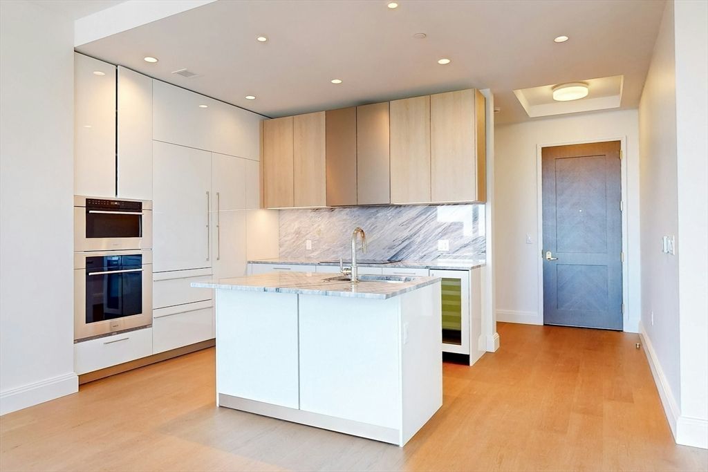 Interior, Kitchen, Marble Walls, Recessed Lighting, Stainless Steel Appliances, Wood Texture Flooring