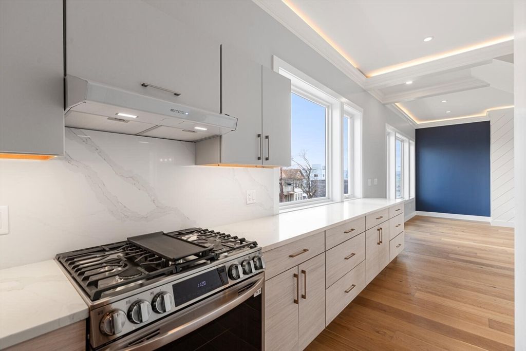 Interior, Kitchen, Marble Walls, Recessed Lighting, Stainless Steel Appliances, Wood Texture Flooring