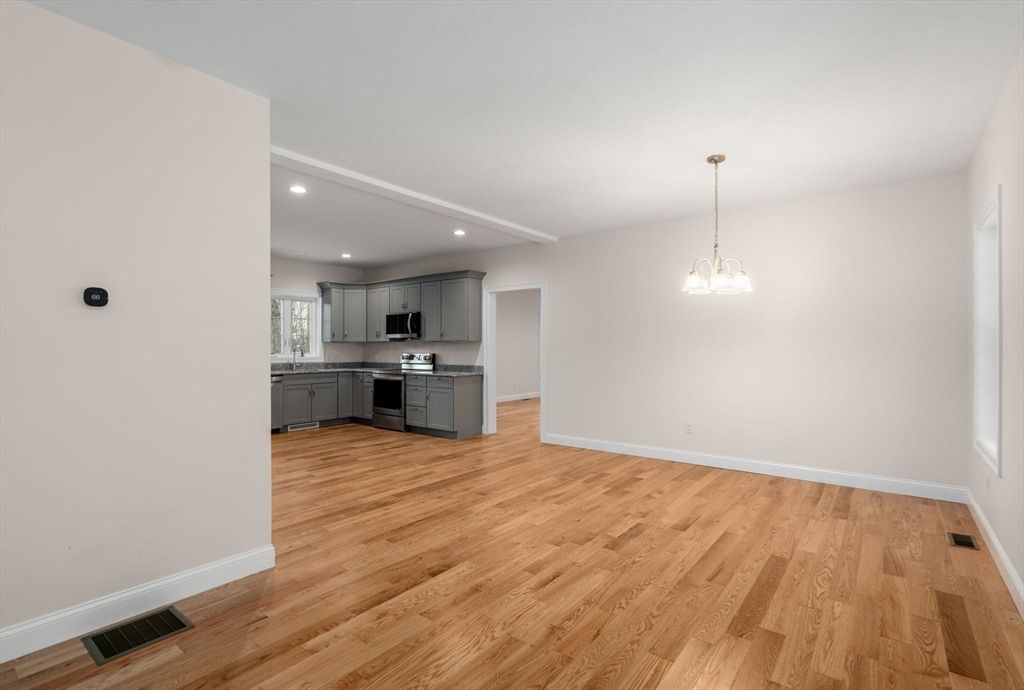 Empty room, Interior, Kitchen, Pendant Lights, Recessed Lighting, Stainless Steel Appliances, Wood Texture Flooring