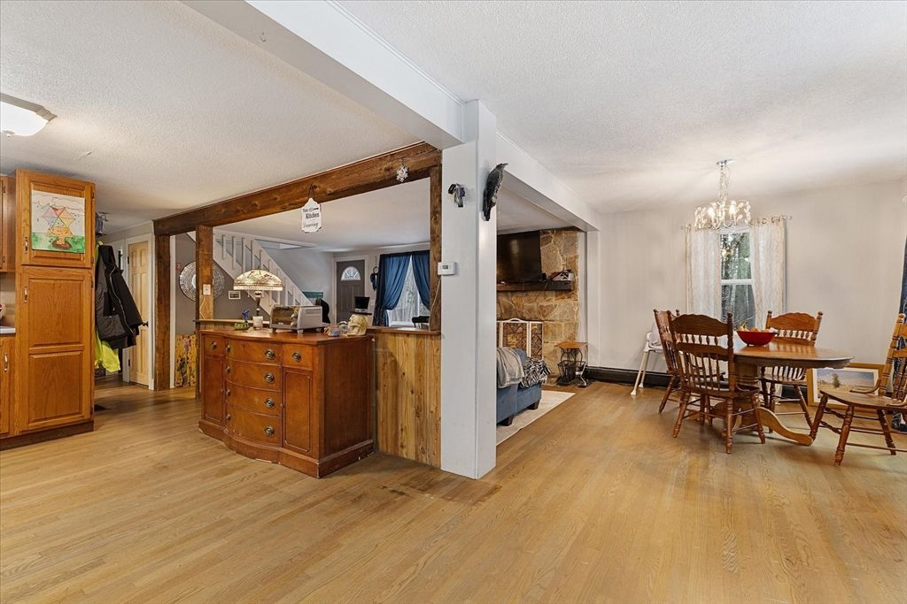 Chandelier, Dining room, Fireplace, Interior, Stone Walls, Wooden Beams, Wood Texture Flooring
