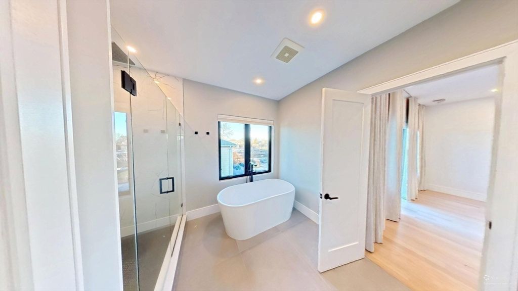 Bathroom, Free Standing Baths, Glass Shower, Interior, Marble Walls, Recessed Lighting, Wood Texture Flooring