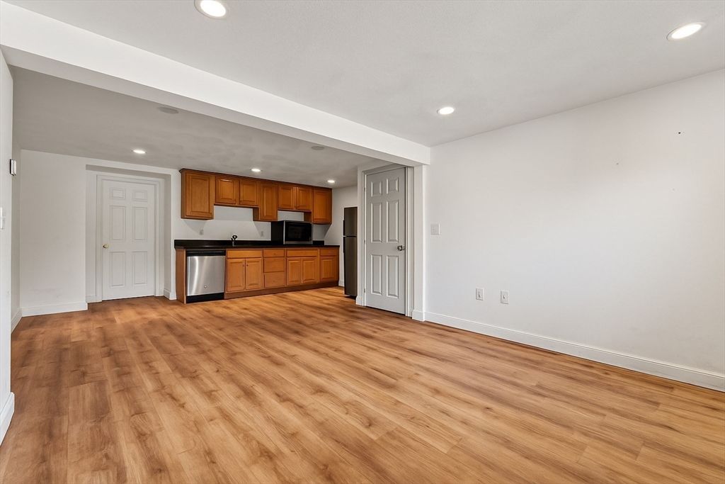 Empty room, Interior, Kitchen, Recessed Lighting, Stainless Steel Appliances, Wood Texture Flooring