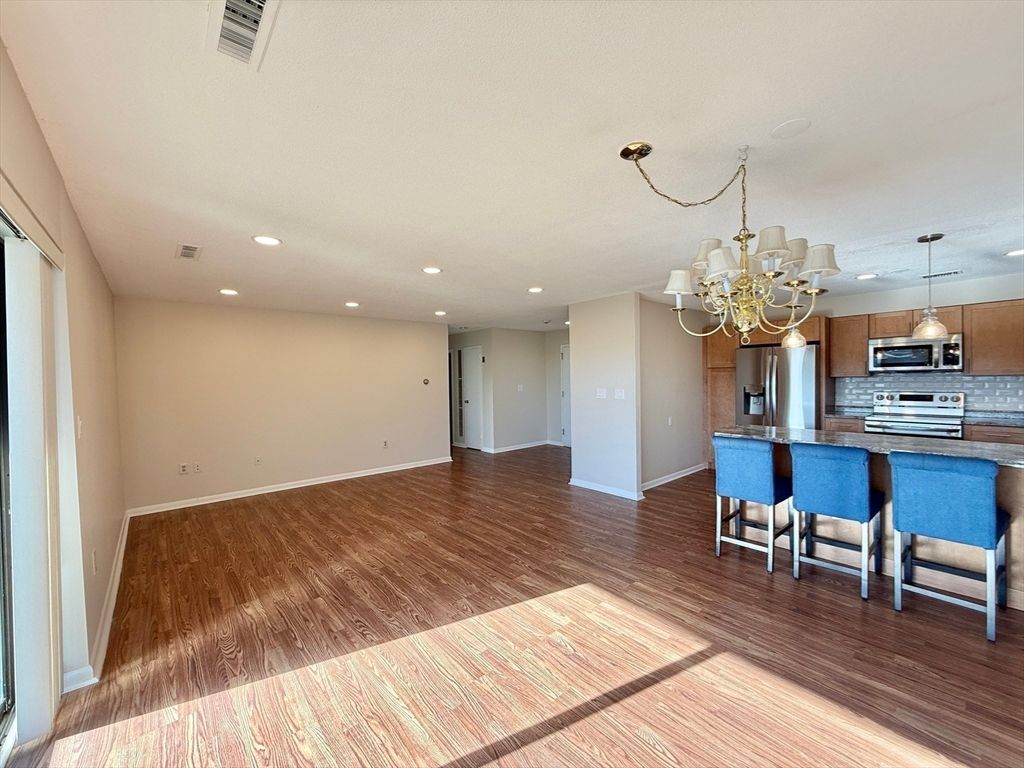 Chandelier, Empty room, Interior, Kitchen, Recessed Lighting, Stainless Steel Appliances, Wood Texture Flooring