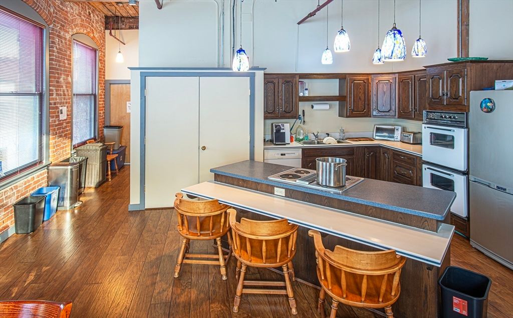 Interior, Kitchen, Pendant Lights, Stainless Steel Appliances, Stone Walls, Wood Texture Flooring