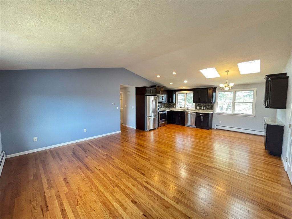 Chandelier, Empty room, Interior, Kitchen, Recessed Lighting, Stainless Steel Appliances, Wood Texture Flooring