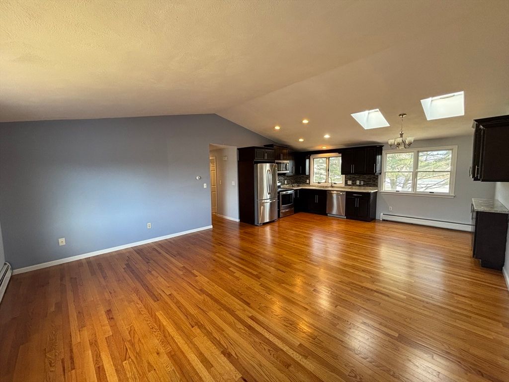 Chandelier, Empty room, Interior, Kitchen, Recessed Lighting, Stainless Steel Appliances, Wood Texture Flooring
