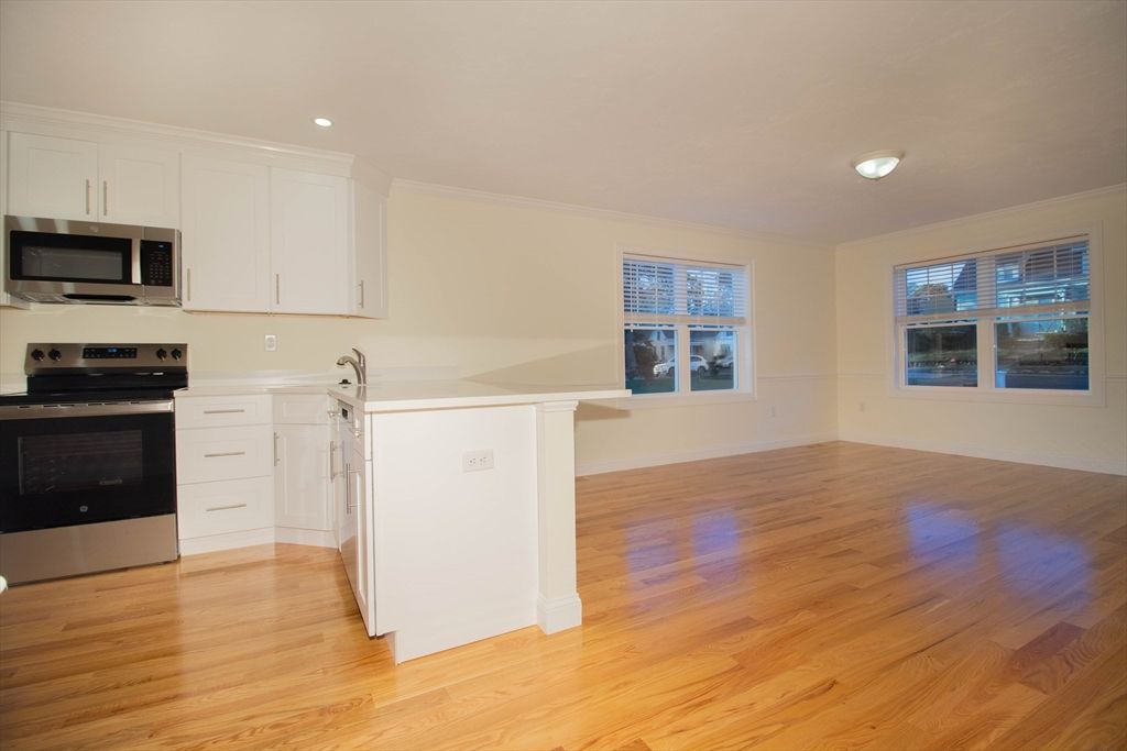 Empty room, Interior, Kitchen, Recessed Lighting, Stainless Steel Appliances, Wood Texture Flooring