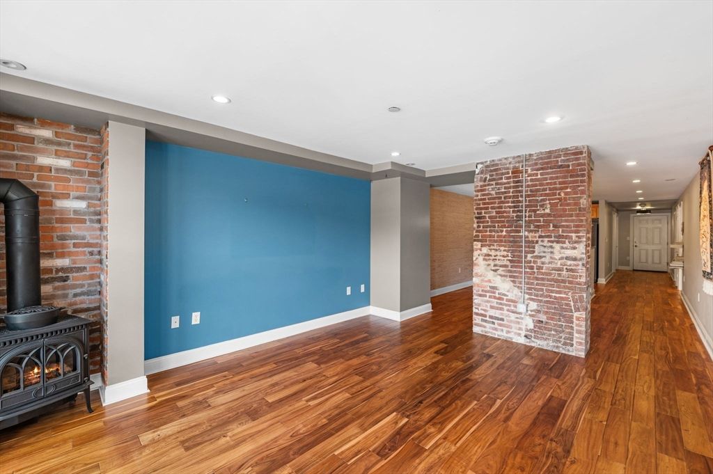 Empty room, Fireplace, Interior, Recessed Lighting, Stone Walls, Wood Texture Flooring