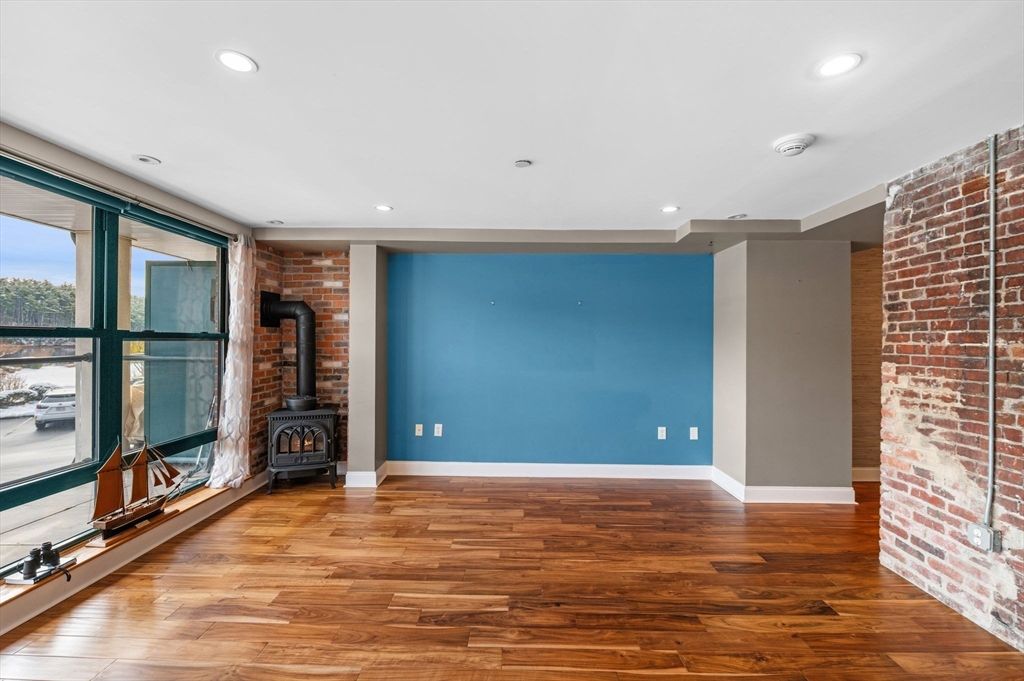 Empty room, Fireplace, Interior, Recessed Lighting, Stone Walls, Wood Texture Flooring