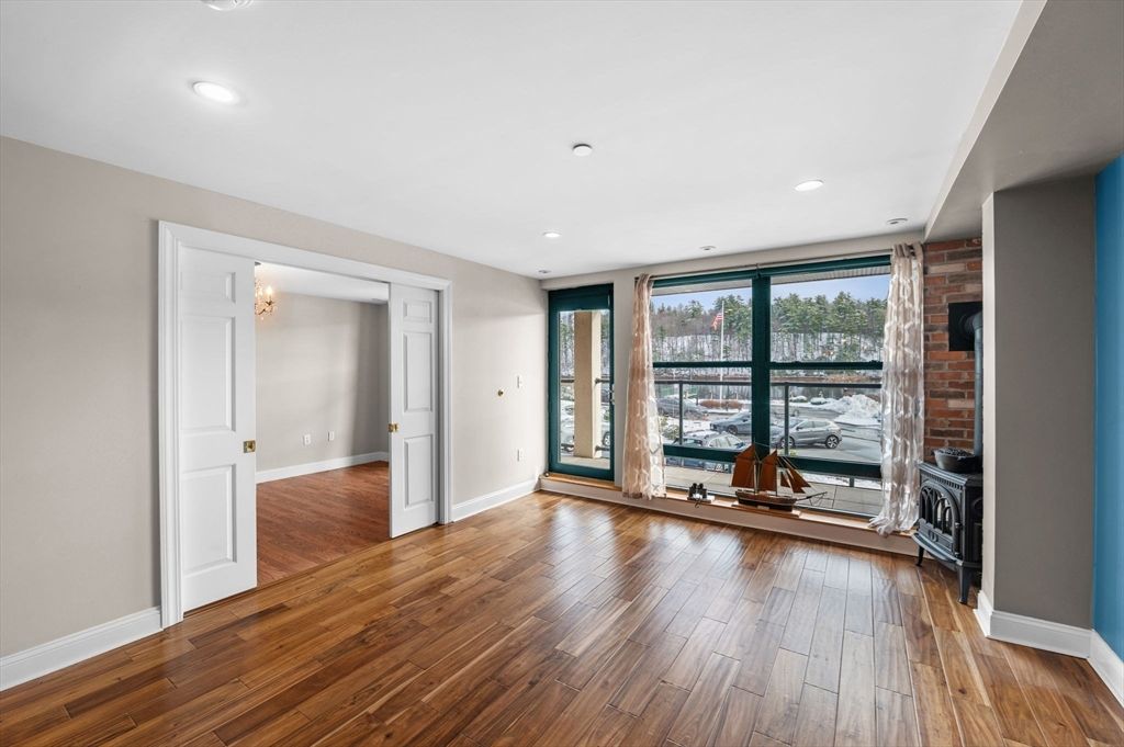 Empty room, Fireplace, Interior, Recessed Lighting, Stone Walls, Wood Texture Flooring