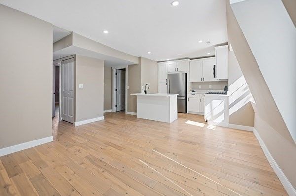 Empty room, Interior, Kitchen, Recessed Lighting, Stainless Steel Appliances, Wood Texture Flooring