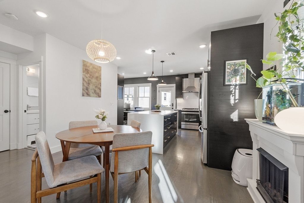 Dining room, Fireplace, Interior, Kitchen, Pendant Lights, Recessed Lighting, Stainless Steel Appliances, Wood Texture Flooring