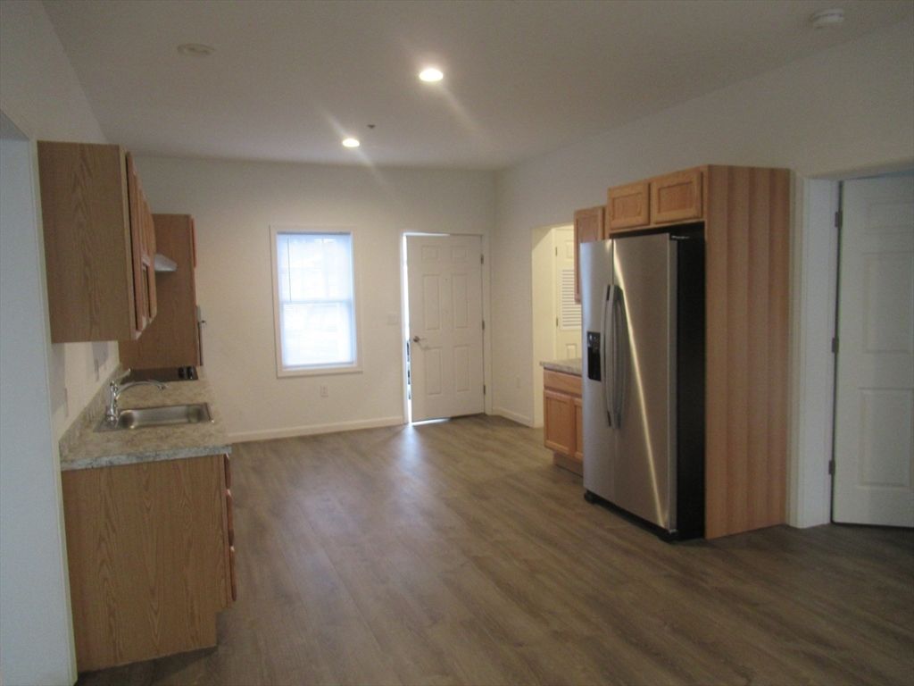 Empty room, Interior, Kitchen, Recessed Lighting, Stainless Steel Appliances, Wood Texture Flooring