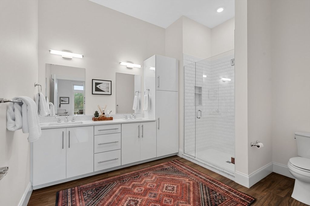 Bathroom, Dual Sink Vanities, Glass Shower, Interior, Recessed Lighting, Wood Texture Flooring