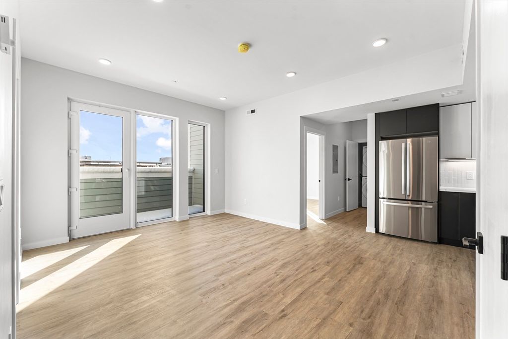 Empty room, Interior, Kitchen, Recessed Lighting, Stainless Steel Appliances, Wood Texture Flooring