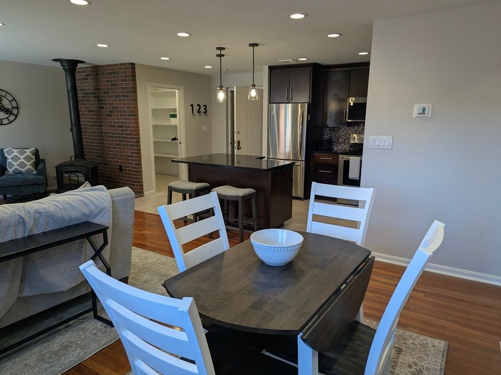Dining room, Interior, Kitchen, Pendant Lights, Recessed Lighting, Stainless Steel Appliances, Stone Walls, Wood Texture Flooring