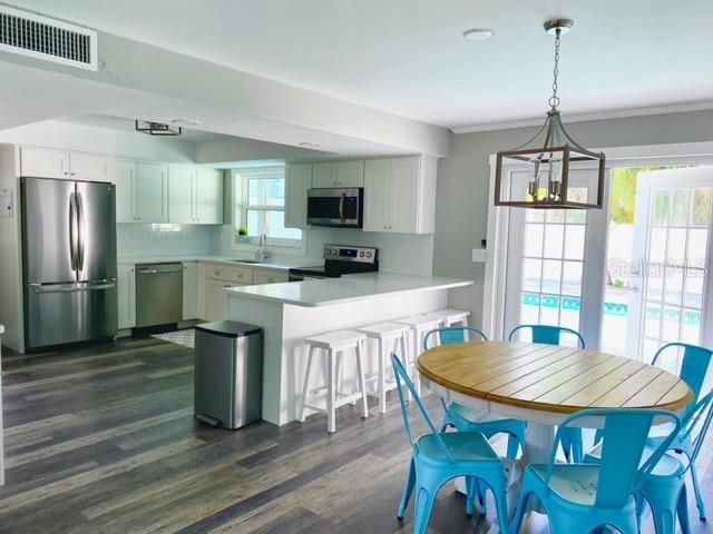 Dining room, Interior, Kitchen, Pendant Lights, Recessed Lighting, Stainless Steel Appliances, Wood Texture Flooring