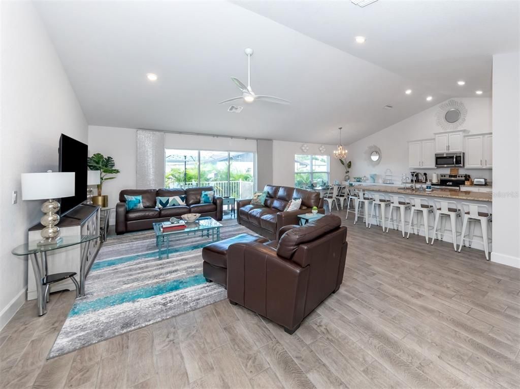 Chandelier, Dining room, Interior, Kitchen, Living room, Recessed Lighting, Stainless Steel Appliances, Wood Texture Flooring