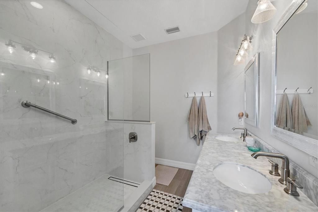 Bathroom, Dual Sink Vanities, Glass Shower, Interior, Marble Walls, Wood Texture Flooring