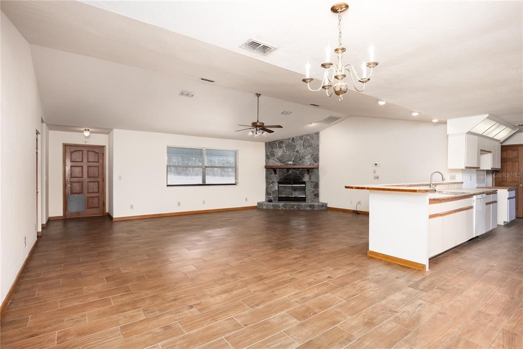 Chandelier, Empty room, Fireplace, Interior, Kitchen, Recessed Lighting, Wood Texture Flooring