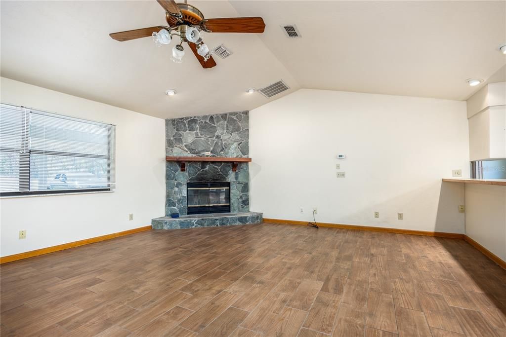 Empty room, Fireplace, Interior, Recessed Lighting, Stone Walls, Wood Texture Flooring