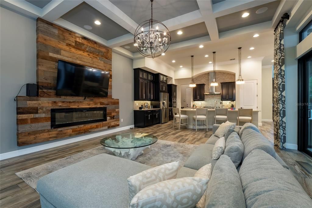 Chandelier, Dining room, Fireplace, Interior, Kitchen, Living room, Pendant Lights, Recessed Lighting, Wood Texture Flooring, Wooden Walls