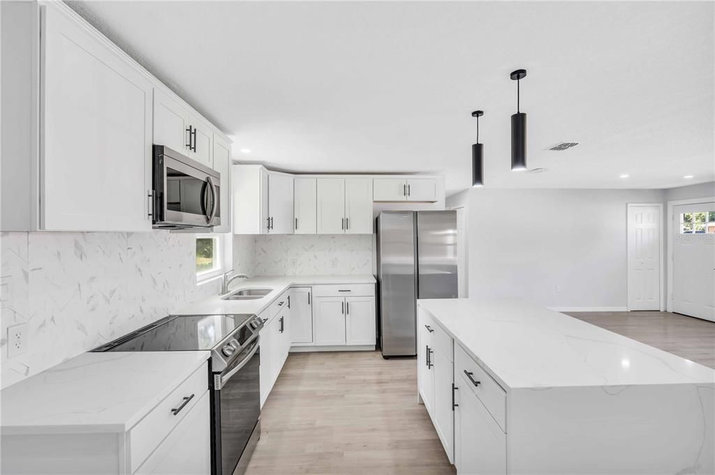 Interior, Kitchen, Marble Walls, Recessed Lighting, Stainless Steel Appliances, Wood Texture Flooring