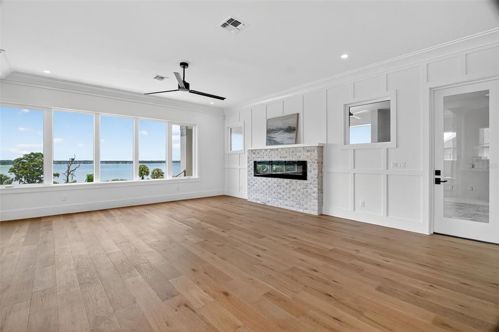 Empty room, Fireplace, Interior, Recessed Lighting, Water, Wood Texture Flooring
