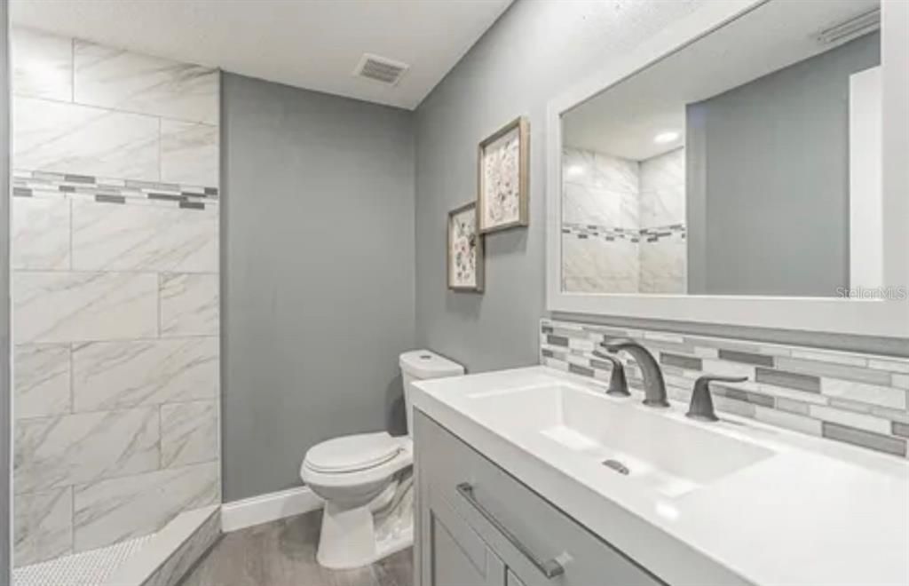 Bathroom, Glass Shower, Interior, Marble Walls, Recessed Lighting, Wood Texture Flooring