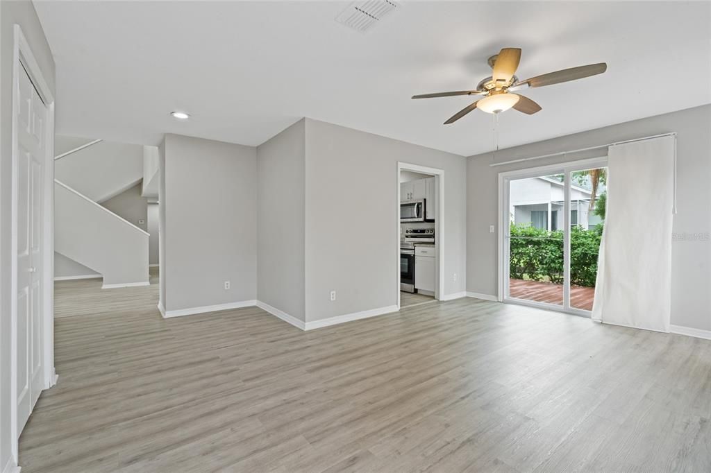 Empty room, Interior, Kitchen, Recessed Lighting, Stainless Steel Appliances, Wood Texture Flooring